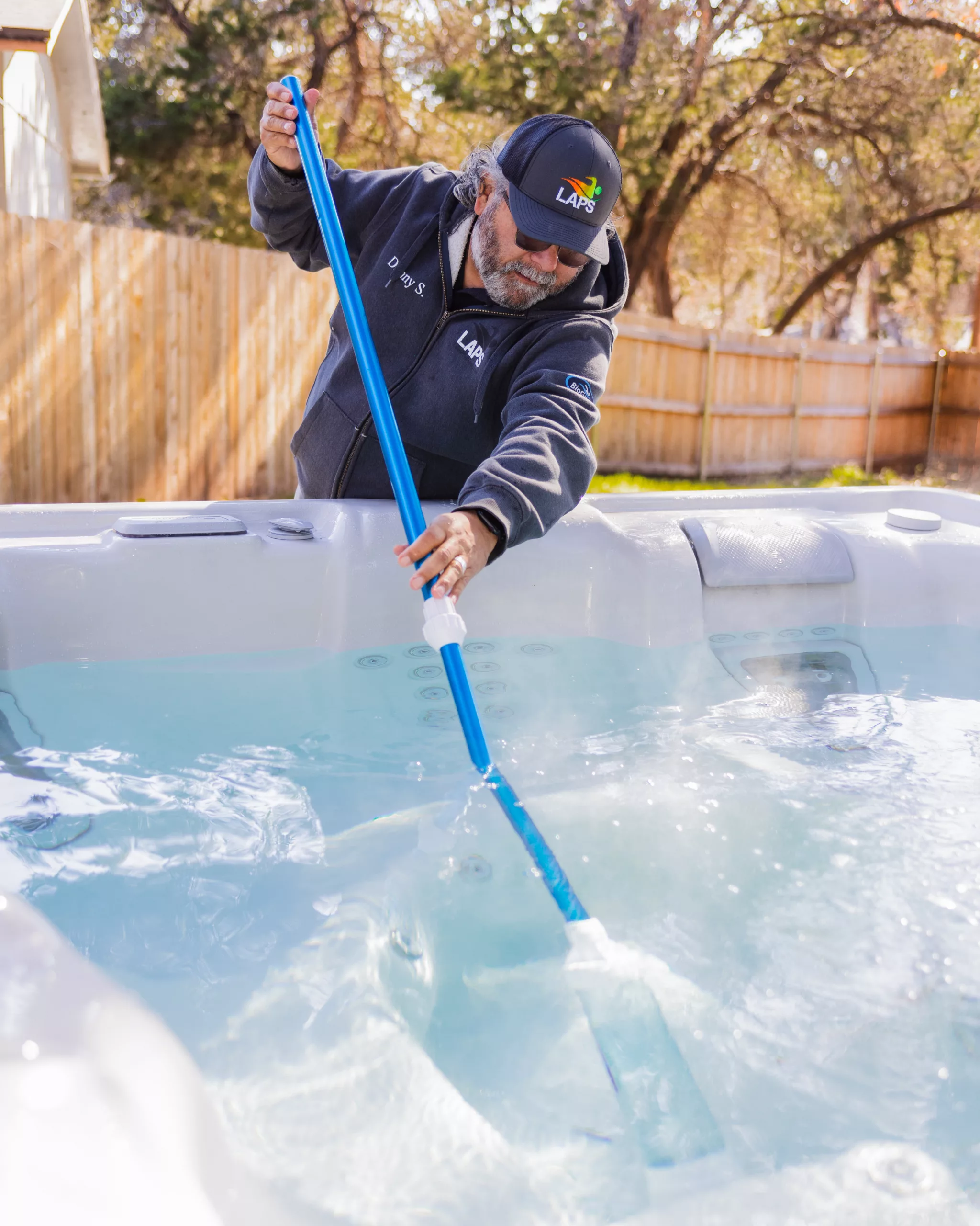 spa service technician cleaning hot tub